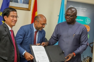 Dr. Bryan Acheampong, Minister for Food and Agriculture signs for the take-off of Food Security in Northern Ghana Project