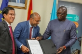 Dr.  Bryan Acheampong, Minister for Food and Agriculture signs for the take-off of Food Security in Northern Ghana Project
